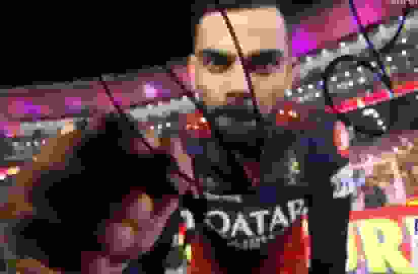 Virat Kohli signs the camera after winning IPL 2025 Final